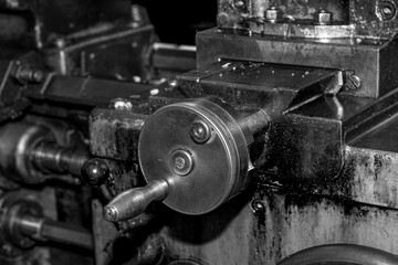 Obraz na płótnie Canvas Metalworking workshop, metal processing machines. Vintage Industrial Machinery in a old factory - black and white photo