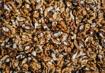 Background, texture of brown walnuts, hazelnuts. Food photography, top view.