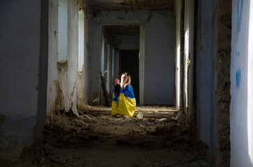 A woman in a bomb shelter. Ukrainian woman in the basement during the war. The girl hides during...