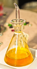 front view, close distance of a glass container with an eye dropper spout filled with aged , expensive, olive oil