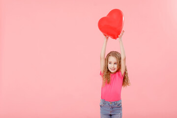 Adorable little girl holding red balloon heart shaped on pink background. Mother's day, valentine's day, love, feeling, family concept.