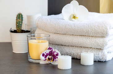 Orchid flowers, spa items, towels isolated on white background with copy space, bathroom.