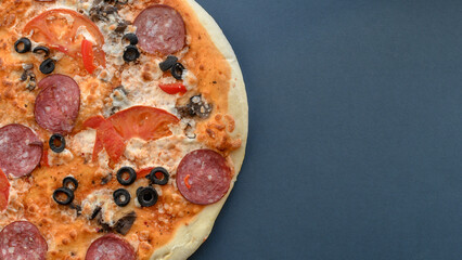 Close up of classic pizza on grey background with copy space. Top view.