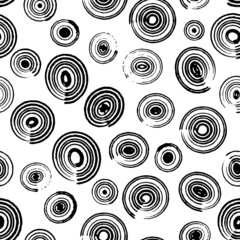 Vector seamless pattern. Repeatable texture with hand drawn round shape brush strokes various size. Artistic monochrome background.