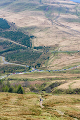 Obraz premium Hiking trail on Blaen-y-Glyn and parked cars in the Brecon Beacons, Wales