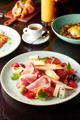 Platter with mortadella sausage, jamon and cheese.