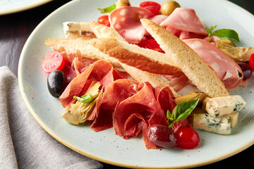 Platter with mortadella sausage, jamon and cheese.