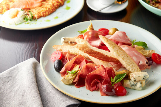 Platter with mortadella sausage, jamon and cheese.