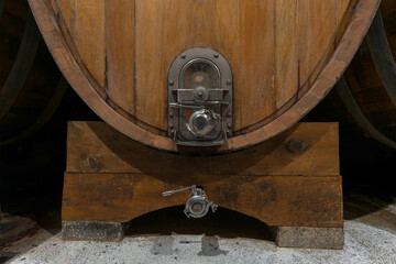 Fototapeta premium Interior of an authentic french wine cellar with old wooden barrels, aging of high quality wine, close-up shot.