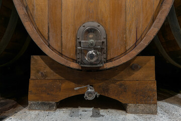 Interior of an authentic french wine cellar with old wooden barrels, aging of high quality wine,...
