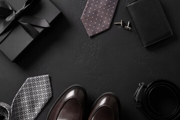 Classic mens accessories - gift, loafers shoes, tie ,belt on black background. Greeting card for Happy Father's Day.