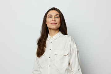 portrait of a beautiful happy attractive adult woman in a white shirt on a white background