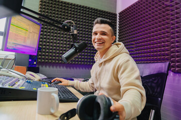 cheery radio host broadcasts live reads news on computer screen.