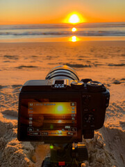 taking a photo of the sunset on the beach of Tarifa in warm orange and yellow tones © samuelfoto