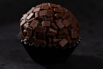 Candy with chocolate sprinkles on a black background