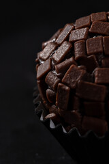 Candy with chocolate sprinkles on a black background