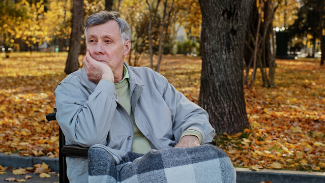 Mature Outdoors Upset Senior Retired Caucasian Man Grandfather Pensioner Sitting Alone In Wheelchair Depressed Pensive Old Male Person Older Age Has Health Problems Feeling Lonely Thinking Of Disease