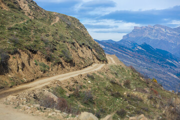 Serpentine road to the village of Goor, Dagestan, Russia. A sharp turn in the road. Beautiful girt road in the mountains. Beautiful landscape