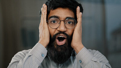 Shocked smiling arabian man professional agent businessman in eyeglasses surprised good news...