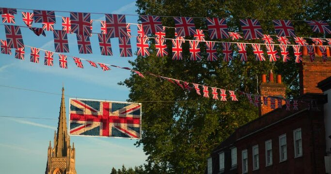 Union Jack flags flying from houses in the streets of Marlow in Buckinghamshire, England celebrating the Platinum Jubilee of Queen Elizabeth the Second in Summer 2022