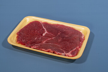 red meat beef in yellow foam board