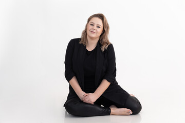 Studio shot of smiling plump and friendly blond woman, posing in white studio. Body positive, love...