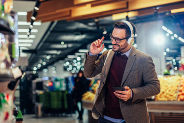 Handsome man enjoying music on earphones