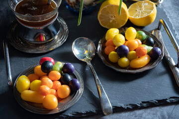 sweet multi-colored candies on plates, beautiful junk food on a dark background