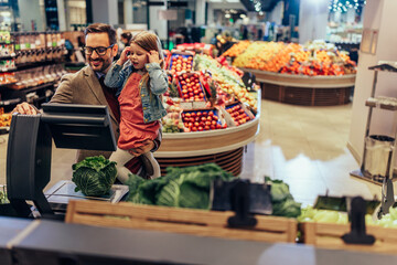 Father and daughter in a groceries store