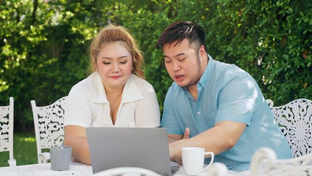 Overweight Couple Enjoy Outdoor Activity Use Laptop To Shopping Online