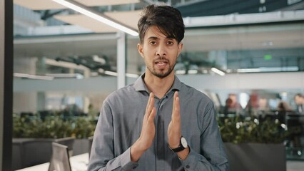Confident arabian businessman financial expert teacher adviser stand indoors tell information in details indian man bank worker specialist talk at camera provide virtual video chat job interview teach