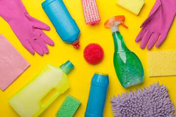 Many different house cleaning products on color background, top view