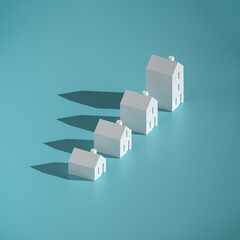 Which size of house can you afford? Concept: four differently sized models of houses on turquoise...