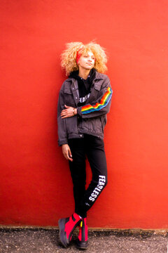 Blond haired woman  against red wall