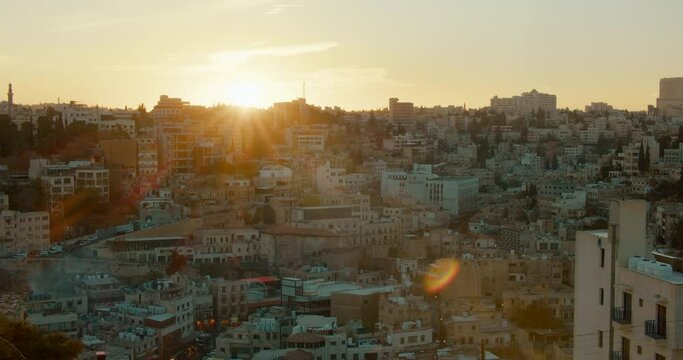 Establishing shot of Arabian Cityscape in Amman, capital of Kingdom of Jordan. Typical houses and buildings Skyline in Middle East City at sunset. Travel and Architecture concept. 4K panoramic view