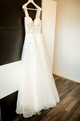 Fototapeta na wymiar Wedding dress on the hanger. White dress on the closet