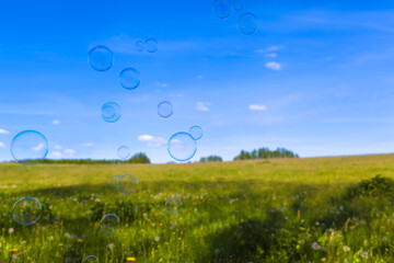 Happy Life Nature / Soap bubbles levitate at wide meadow landscape (copy space) - 506958477