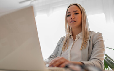 Business woman in office working on lap top