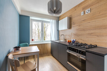 Minimalist kitchen with handleless fronts, no tall cabinets. Budget renovation in housing, area of ​​ten square meters