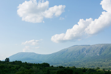Beautiful panorama view of Suva Planina, a chain of mountains and hills in Serbia, with forests, hills and agricultural fields on a spring sunny day