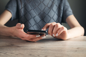 hand of woman using smartphone