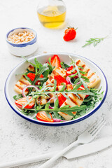 Grilled halumi salad with pine nuts, strawberries and arugula.