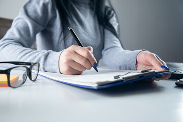 Fototapeta premium Woman signing document and hand holding pen
