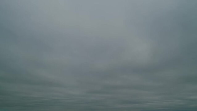 Overcast clouds dissipate into clear blue skies. Weather change. Time lapse.