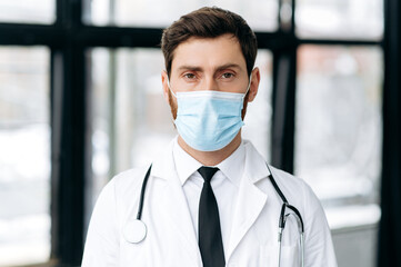 Portrait of Caucasian proud male doctor, therapist, surgeon, cardiologist in a medical uniform,...