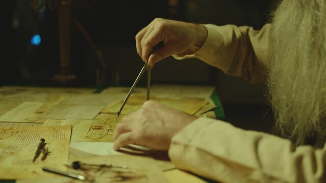 Old man or duplicate of LEONARDO DA VINCI writing , painting , working with divider in vintage designed room . Big drawing of famous artwork . Using , turning compass in Slow motion . 15 -16th century
