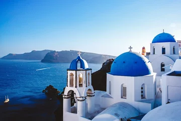 Fototapeten Vacation on Santorini island, Travel to Greece. The blue dome of the white church near the sea and caldera. © 9parusnikov
