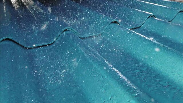 Slow motion of heavy rain on green tiled roof of a house, Slider shot
