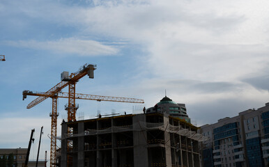 The crane carries the slab. Construction of a new apartment building. High quality photo