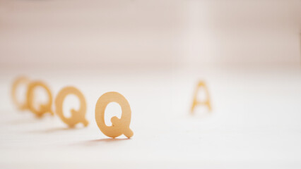 Q A or Questions and answers on wood text with sunshine background.